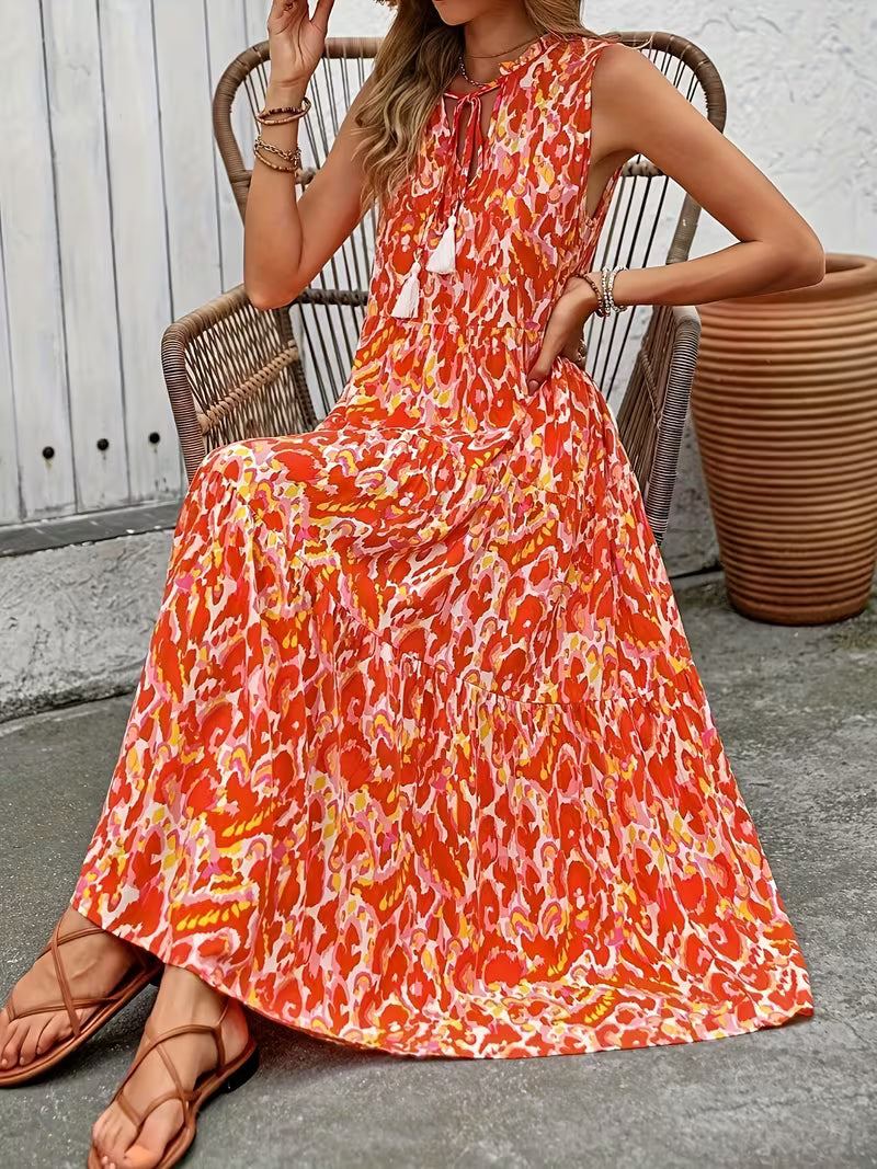 Robe midi bohème imprimée, sans manches, avec liens à pompons, légère et fluide, parfaite pour un look estival chic, fun et résolument bohème